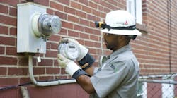 A Georgia Power employee replaces a mechanical meter with a digital &apos;smart&apos; meter in 2009. The meters are a part of the company&apos;s smart grid, which is reducing the frequency and duration of power outages.
