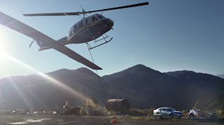 A SCE helicopter takes off from the fuel site at Soledad Canyon as part of the Sand Fire restoration effort. Helicopters airlifted distribution equipment, set poles and conducted a sock line pull. Linemen eventually set 30 poles and pulled 24 spans of wire with the helicopters&rsquo; help.