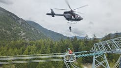 BC Hydro power line technician Matt Husty gets hoisted into Ascent&rsquo;s MD902 while PLT apprentice Jordan Gesic waits his turn in Lillooet, British Columbia, in May 2016.