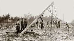 In the early days of the line trade, linemen worked in large crews without personal protective equipment, hard hats or flame-retardant clothing. Courtesy of Alabama Power