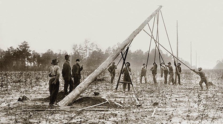 In the early days of the line trade, linemen worked in large crews without personal protective equipment, hard hats or flame-retardant clothing. Courtesy of Alabama Power