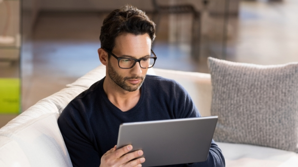man looking at tablet
