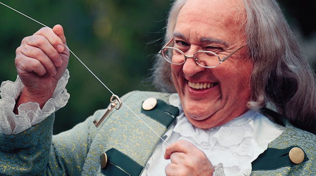 Portrait of man dressed as Benjamin Franklin with key and kite