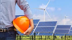 engineer stand holding yellow safety helmet front solar photovoltaics and wind turbines generating electricity power station background