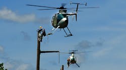 Stepping off a hovering helicopter to perform construction tasks is not the traditional method of building transmission lines, but it is proving to be highly cost effective and efficient.