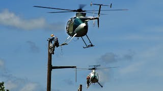 Stepping off a hovering helicopter to perform construction tasks is not the traditional method of building transmission lines, but it is proving to be highly cost effective and efficient.