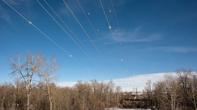 Diverters increase visibility of power lines across the Gallatin River in Montana, reducing the likelihood of bird collisions. Photos by Susan Malee, NorthWestern Energy.