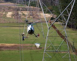 Helio linemen perform many types of maintenance tasks from the platform of a hovering helicopter.