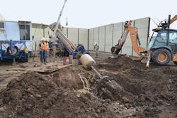 A cable conduit bundle is pulled through the 36-inch-diameter bore hole.