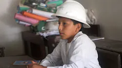 student in Bolivia with hardhat