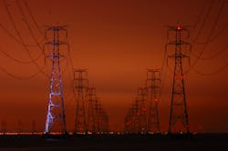 transmission towers against dark sky transmission towers against dark sky