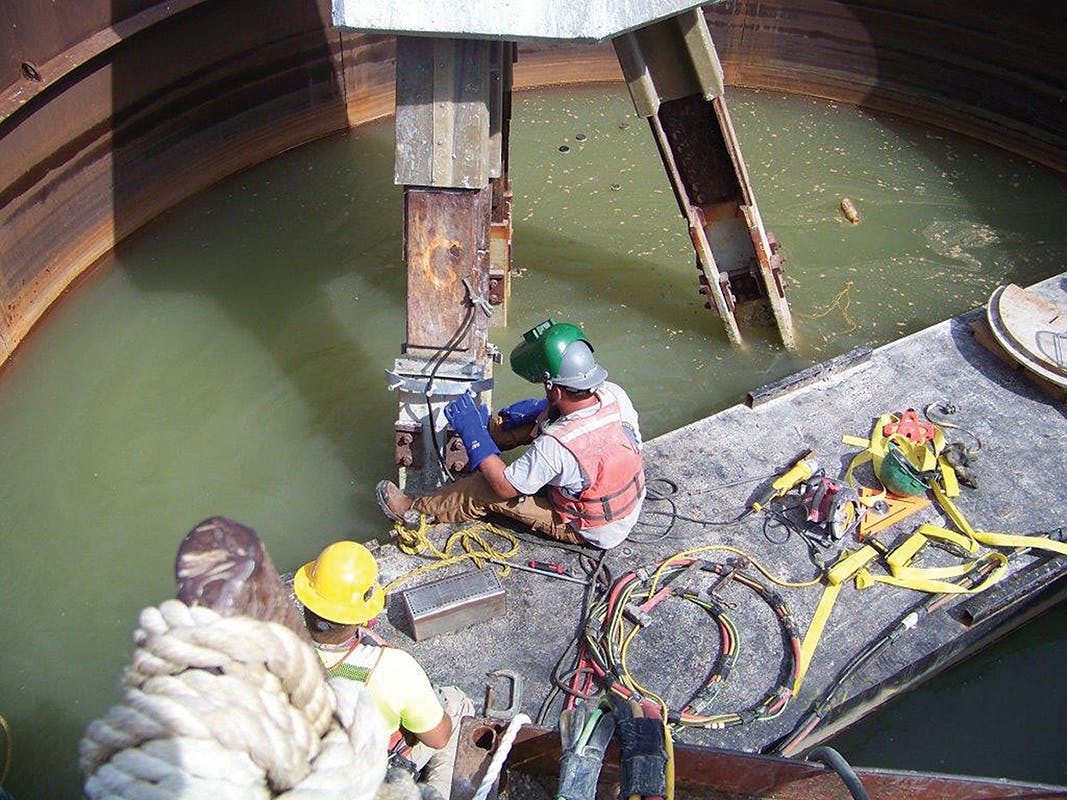 A crews installs the upper shear clips required for pier addition.