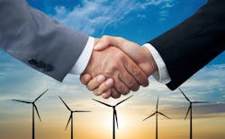 handshake in front of wind turbines handshake in front of wind turbines