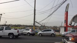 Photos of Hurricane Maria&apos;s damage in San Juan show destroyed poles that in some places are only being held up by main power and communications distribution lines.