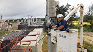 GPA customer service field technicians perform maintenance on communications equipment positioned near power station service in northern Guam.