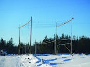 Dielectric safety netting on rider poles is used for stringing over a Manitoba Hydro DC electrode line.