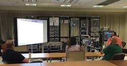 The engineering and operations teams meet in the lab area to collaborate on IEC 61850 strategy.