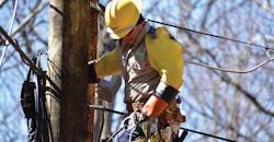 A NOVEC lineman wears personal protective equipment to stay safe while restoring power in Fairfax Station, Virginia. Photo by Matt Robertson.