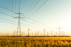Corn field with power poles and wind turbines. Photo taken in autumn sunlight shortly before sunset. Corn field with power poles and wind turbines. Photo taken in autumn sunlight shortly before sunset.