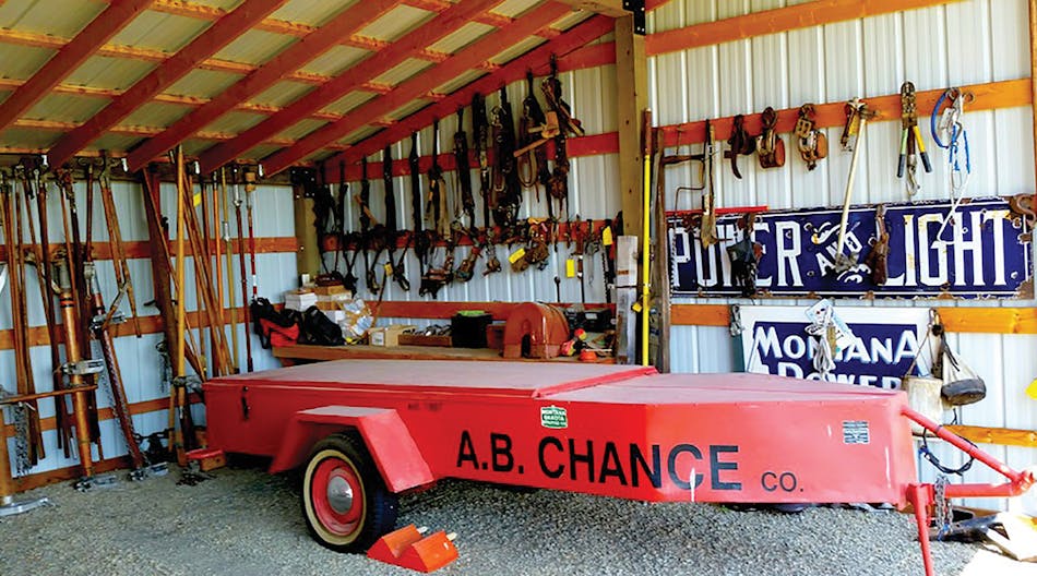 A cherry red 1960s half-back Delphi hot stick trailer takes center stage in barn for his antique line tools.