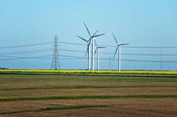 Meadow with Wind mill turbines generating electricity and electric power lines, in England, the UK Meadow with Wind mill turbines generating electricity and electric power lines, in England, the UK
