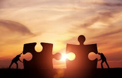 Two businessman connecting puzzle pieces togheter with copy space Two businessman connecting puzzle pieces togheter with copy space