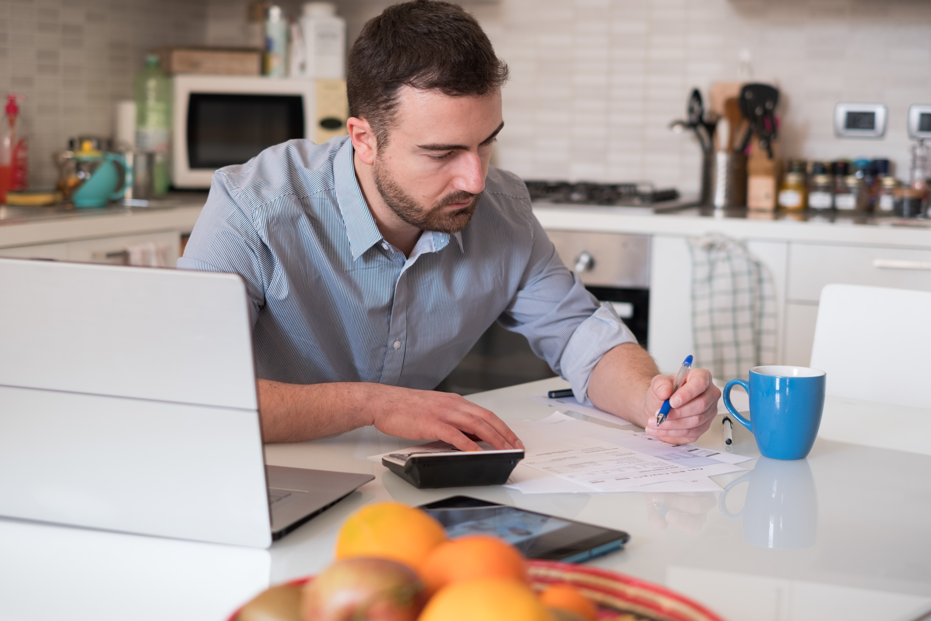 Man calculating bills and tax expenses