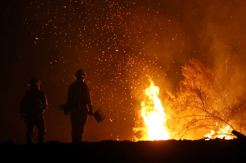 Cal Fire firefighters monitor a back fire