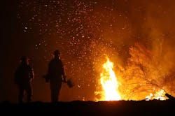 Cal Fire firefighters monitor a back fire Cal Fire firefighters monitor a back fire