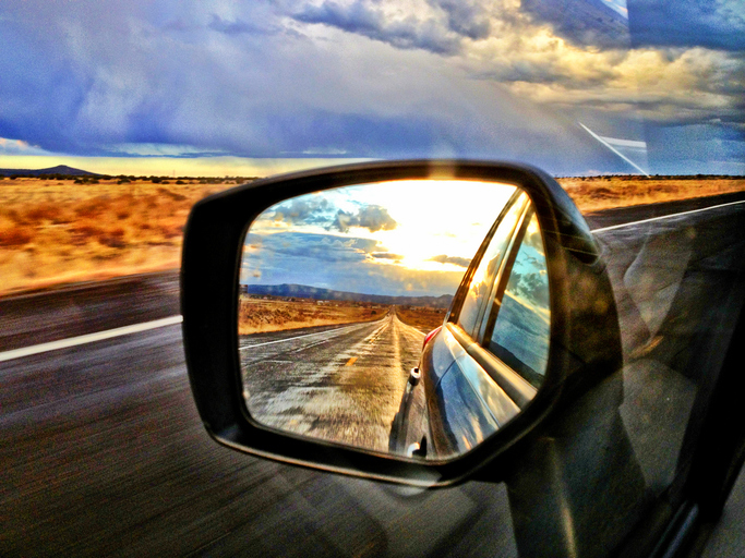 Window and mirror view on the road in the American Southwest.