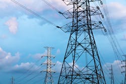 high-voltage power lines at blue sky electricity transmission pylon. Part of high-voltage substation with switches and disconnectors high-voltage power lines at blue sky electricity transmission pylon. Part of high-voltage substation with switches and disconnectors