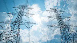 Two power tower agaist clouds and blue sky