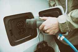 Male Hand Charging The Electric Car Male Hand Charging The Electric Car