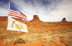 american and navajo flags waving in monument valley american and navajo flags waving in monument valley