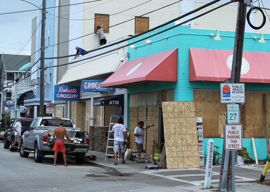 Workers board up shops