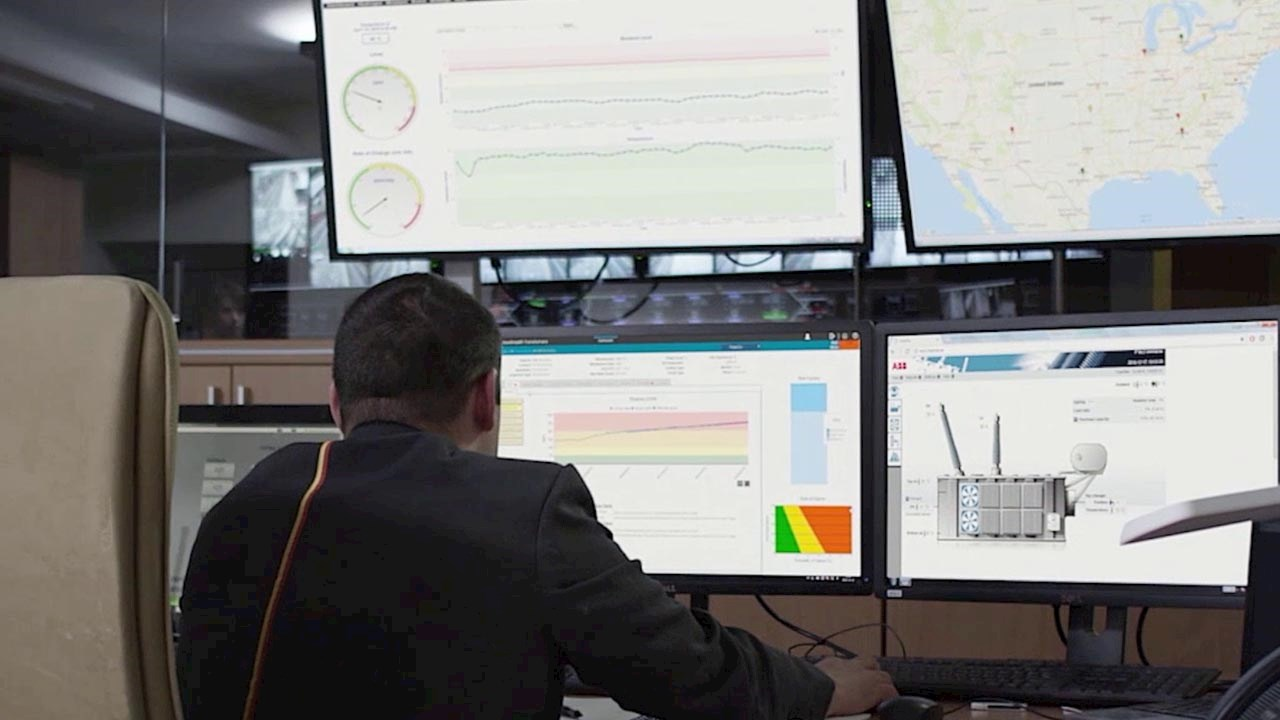 man at computer screens