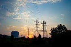A view of the electrical towers and industrial storage tanks at sunrise in Sayerville NJ. A view of the electrical towers and industrial storage tanks at sunrise in Sayerville NJ.