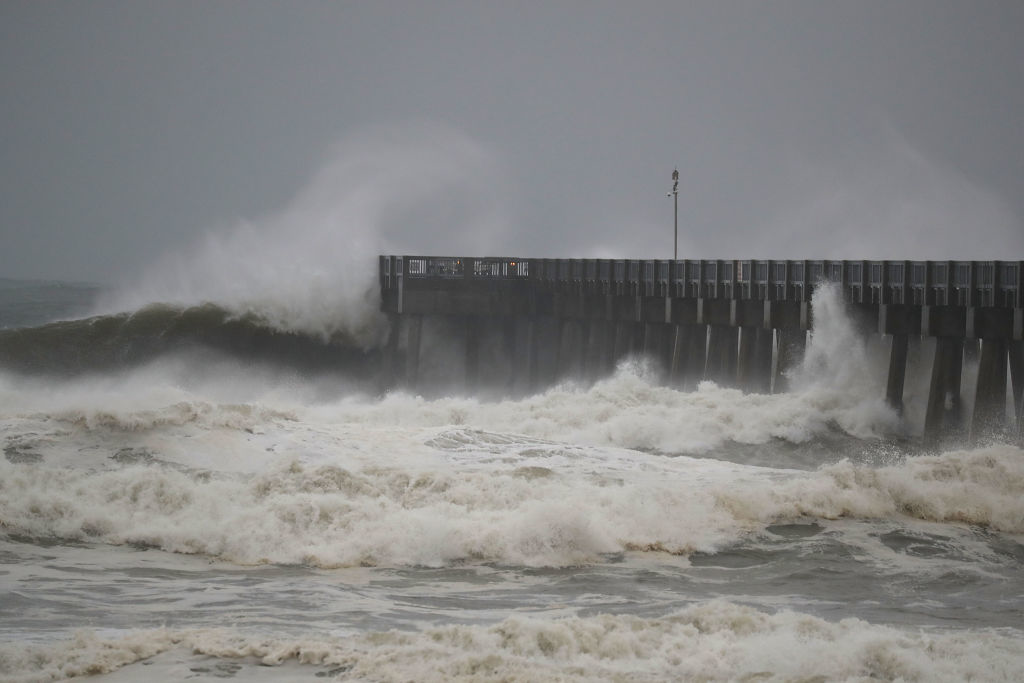 Waves crash along a pier