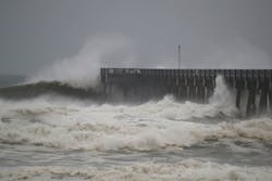 Waves crash along a pier Waves crash along a pier