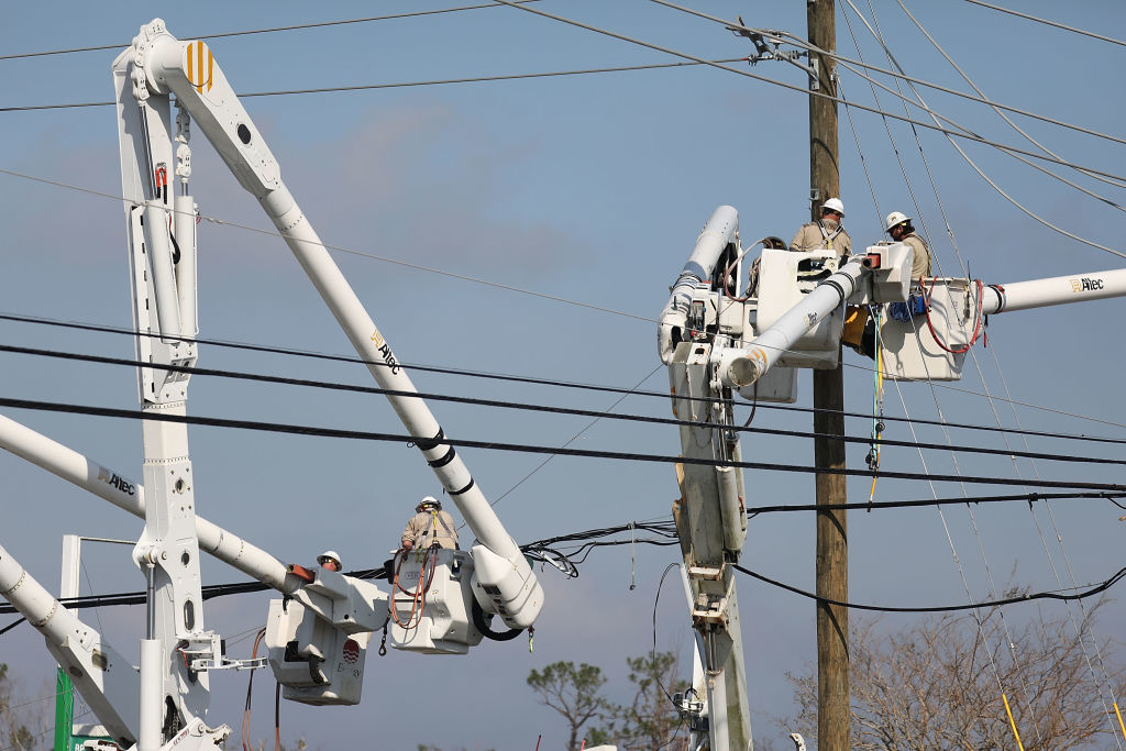 Workers repair the electrical grid