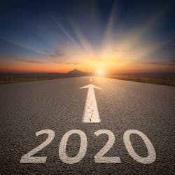 Upcoming 2020 new year on empty highway leading to the mountains through the desert against the rising sun. Upcoming 2020 new year on empty highway leading to the mountains through the desert against the rising sun.
