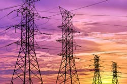 Four high voltage electric tower pylons contrasting against a brightly glowing evening sunset. Four high voltage electric tower pylons contrasting against a brightly glowing evening sunset.