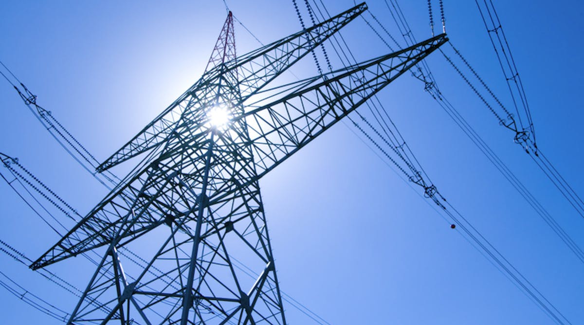 Electricity pylon with blue sky and sun