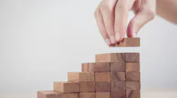 Woman hand arranging wood block stacking as step stair. Business concept growth success process.