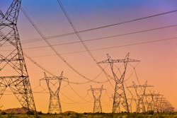 a Series of electrical transmission tower with power lines criss crossing at sunset. a Series of electrical transmission tower with power lines criss crossing at sunset.