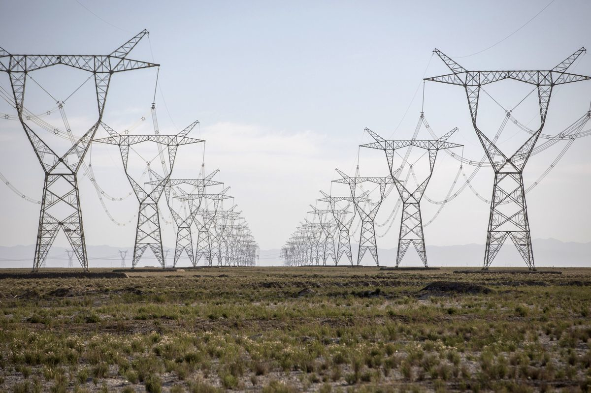 Power lines carrying electricity from the Golmud Solar Park hang from transmission towers on the outskirts of Golmud, Qinghai province, China, on Wednesday, July 25, 2018. China has emerged as the global leader in clean power investment after it spent $127 billion in renewable energy last year as it seeks to ease its reliance on coal and reduce smog in cities, according to a report jointly published by the United Nations and Bloomberg New Energy Finance in April. Photographer: