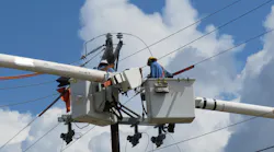 linemen in utility truck working on electrical equipment