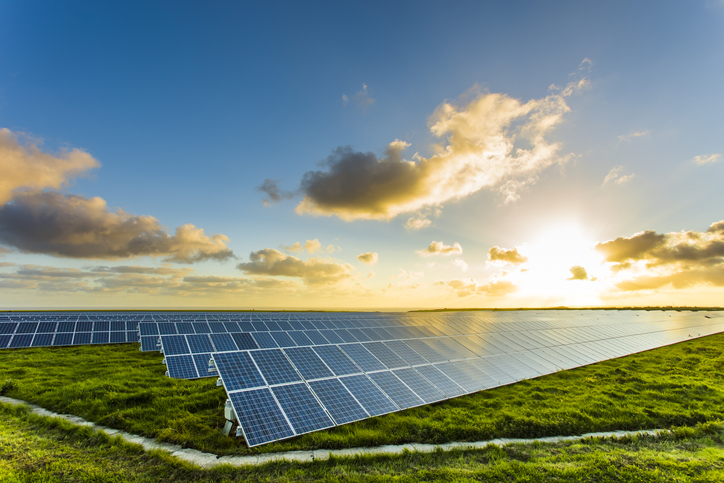 Solar panels at sunrise with cloudy sky