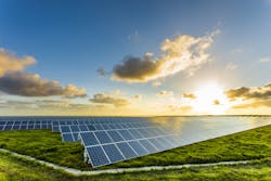 Solar panels at sunrise with cloudy sky Solar panels at sunrise with cloudy sky