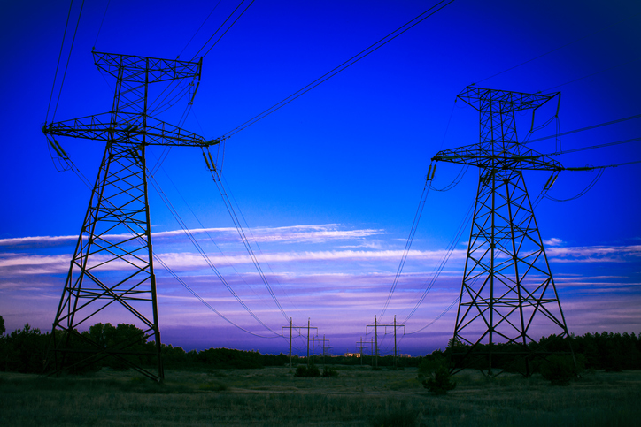 high-voltage power lines at sunset. electricity distribution station .